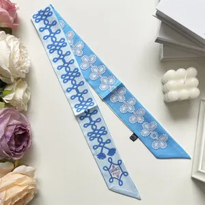 Detailed close-up of blue nautical rope print silk twilly with France Paris lettering