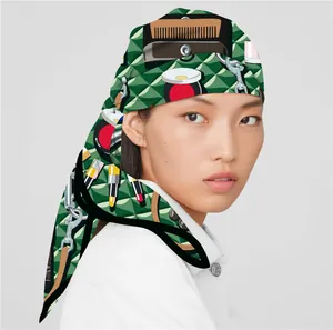 Detail of silk-feel scarf featuring green geometric patterns and beauty illustrations