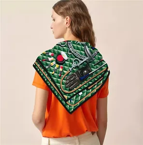 Close-up of dark green silk square scarf with French cosmetic and harness print patterns