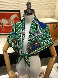 Detailed view of dark green silk scarf with equestrian horse bit pattern on mannequin