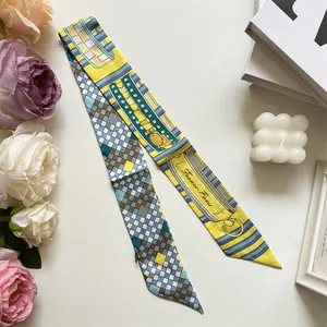 Detail of yellow silk scarf with blue geometric patterns and France-Paris typography