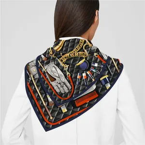 Detail of silk-feel scarf featuring vintage accessory prints and vibrant orange borders