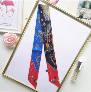 Detail of vintage printed silk scarf with classic key patterns and a soft glossy texture