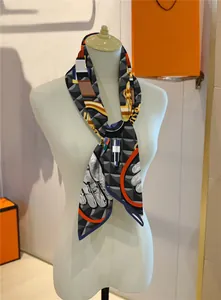 Detail of silk-feel scarf with geometric 3D pattern and BEAUMÉ COMPOSÉ lettering