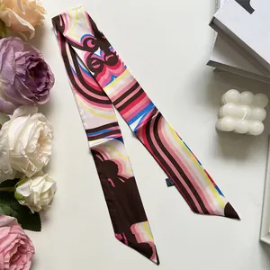 Close-up of orange skinny twilly silk scarf with colorful retro geometric pattern