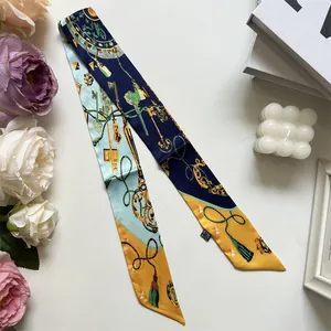 Elegant skinny silk scarf with vintage gold key and chain print in navy blue and orange