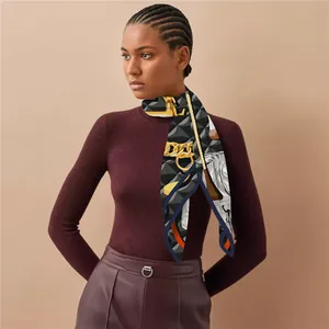Detail of luxury geometric silk scarf with vintage gold chain print and navy blue border