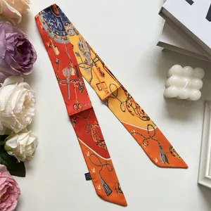 Detail shot of vintage key and chain printed narrow silk scarf with floral decor
