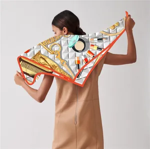 Detail of silk-feel 90cm square scarf with cosmetic prints draped on woman shoulders