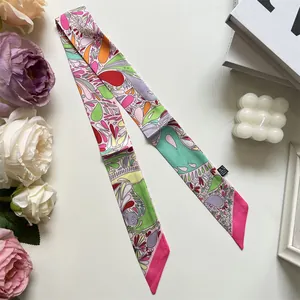 Flat-lay view of twilly silk scarf with floral paisley patterns and pointed ends