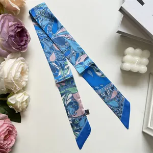 Detail of royal blue paisley silk scarf with satin finish and diagonal cut ends