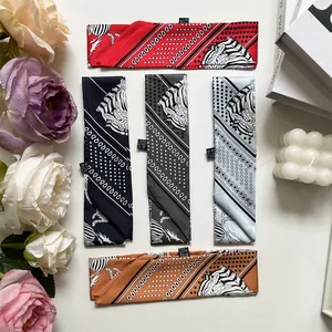 Flat lay of five faux silk skinny scarves with zebra and geometric patterns