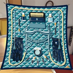 Detailed pattern of the silk square scarf featuring makeup tools and teal geometric designs