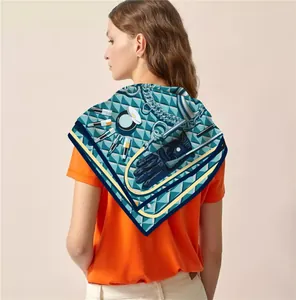 Rear view of silk-feel square scarf as shawl with chic blue geometric beauty print