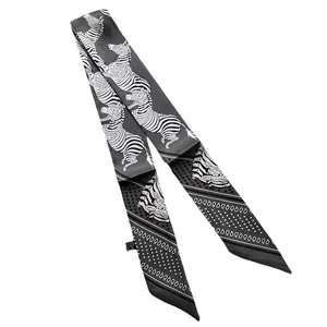 Double-sided silk-like twilly scarf with zebra print and paisley patterns on grey fabric