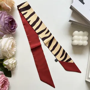 Dual-sided skinny silk scarf with zebra print and deep red finish for bag handles