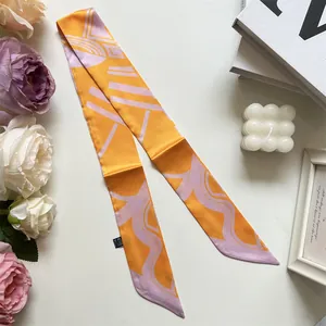 Detailed view of an orange twilly silk scarf with abstract geometric texture pattern