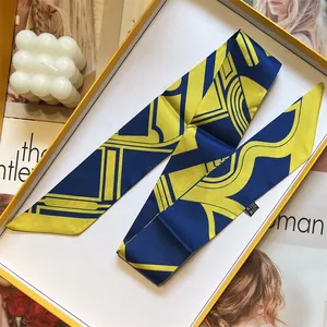 Elegant geometric twill silk scarf for women in a luxury gift box with fashion props