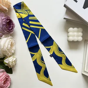 Close-up of geometric pattern silk scarf with washing label on a lifestyle backdrop