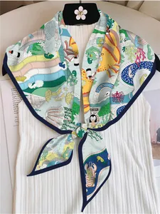 Detail of colorful twill silk scarf with amusement park print tied on a striped shirt