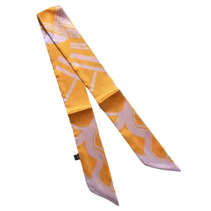 Orange twilly silk scarf with purple geometric pattern on a white background