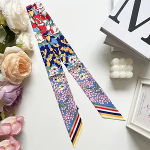 Detailed close-up of a twilly silk scarf with floral prints and colorful striped ends
