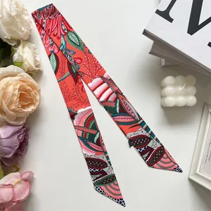 Close-up view of vibrant vintage floral pattern on a long silk scarf ribbon accessory.