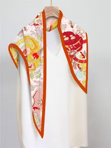 Detail of vibrant orange silk scarf with sea horse and seashell nautical illustrations