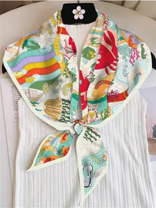Detail of colorful marine theme silk scarf with sea horse and coral prints on a striped top