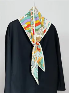 Detail of silk twill scarf showing vivid sea world prints and paddling letter motifs