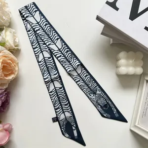 Close-up of zebra pattern double-sided twilly scarf with detailed washing label