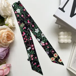 Detail of floral skinny scarf tied as a bag ribbon with elegant home decor background