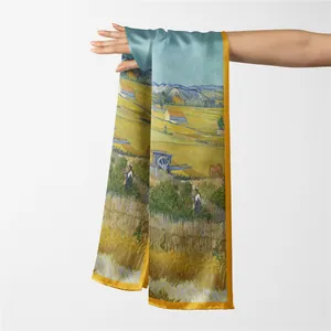 Detail of silk texture scarf featuring Van Gogh Harvest painting print and yellow satin edge
