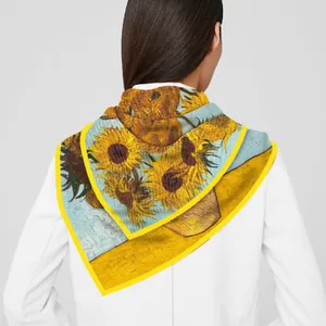 Detail of Van Gogh Sunflowers print on silk scarf draped over a white shirt