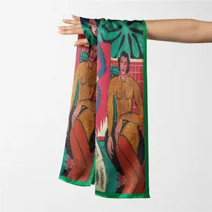Detail of Henri Matisse style silk scarf with green border held by hand against a wall