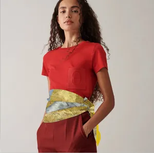 Artistic printed silk scarf used as a waist belt with deep red outfit for women