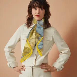 Close-up of yellow impressionist art silk scarf tied around neck over a beige denim jacket