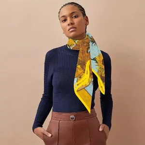 Detail of Van Gogh sunflower print silk scarf with yellow stitched edges and vibrant colors