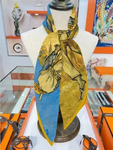 Artistic Van Gogh Sunflower print silk scarf draped on a mannequin in a boutique setting
