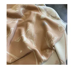 Detail of cashmere shawl with Eiffel Tower jacquard pattern and soft fringe edges
