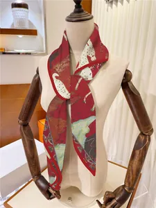 Detail of red silk scarf with abstract ink painting pattern on a mannequin arm