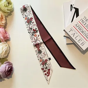 Detail of a floral print silk twilly scarf showing double-sided design and texture