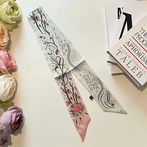 Close-up of a gradient floral twilly scarf featuring botanical prints and satin texture