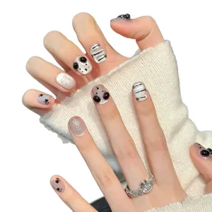 Handcrafted press-on nails with 3D cat ears and silver bowknot designs on short square tips
