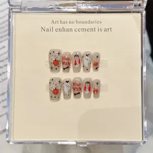 Macro shot of Halloween cartoon pumpkin and ghost hand-painted coffin press-on nails