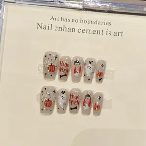 Halloween coffin press-on nails set featuring pumpkin, ghost and spider web patterns