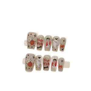 Halloween press-on nails with orange pumpkin and cute ghost designs on gray base