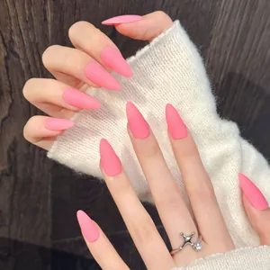 Matte hot pink long stiletto press-on nails shown on hand with a silver ring