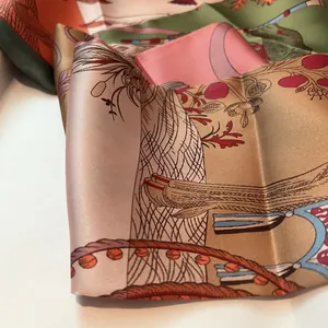 Macro shot of silk scarf showing detailed classical pattern with fruits and tassels