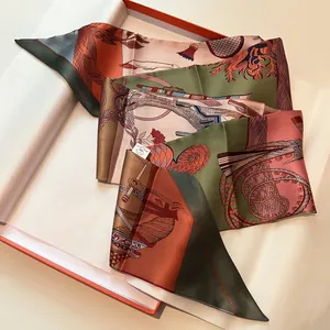 Artistic silk twilly scarf with equestrian print inside an orange luxury gift box